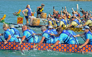 Teams of 20 paddlers power their sleek 40-foot-long boats in unison, racing parallel to the shore.